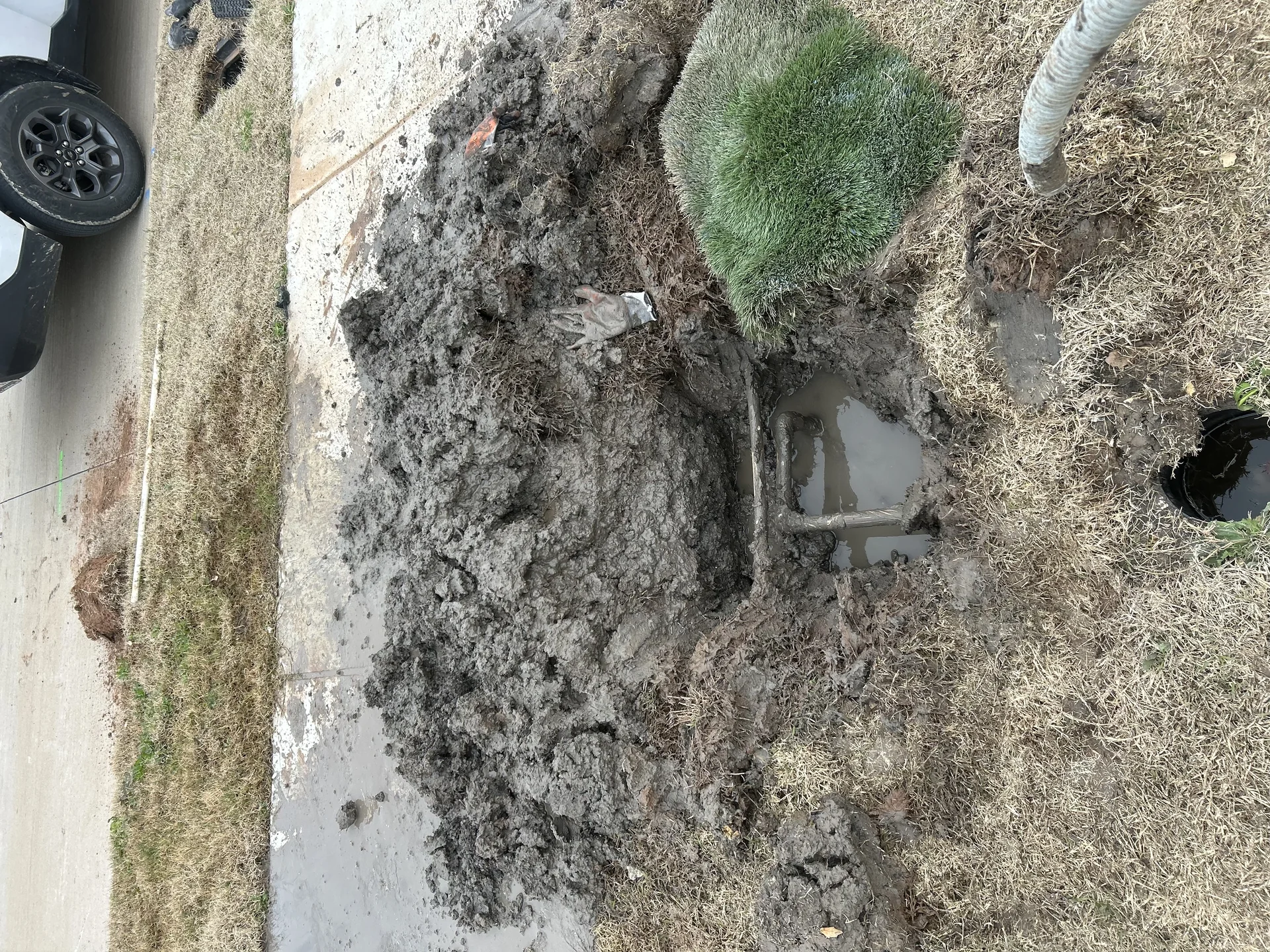 Deep trench exposing expansive Blackland Prairie clay soil along residential foundation