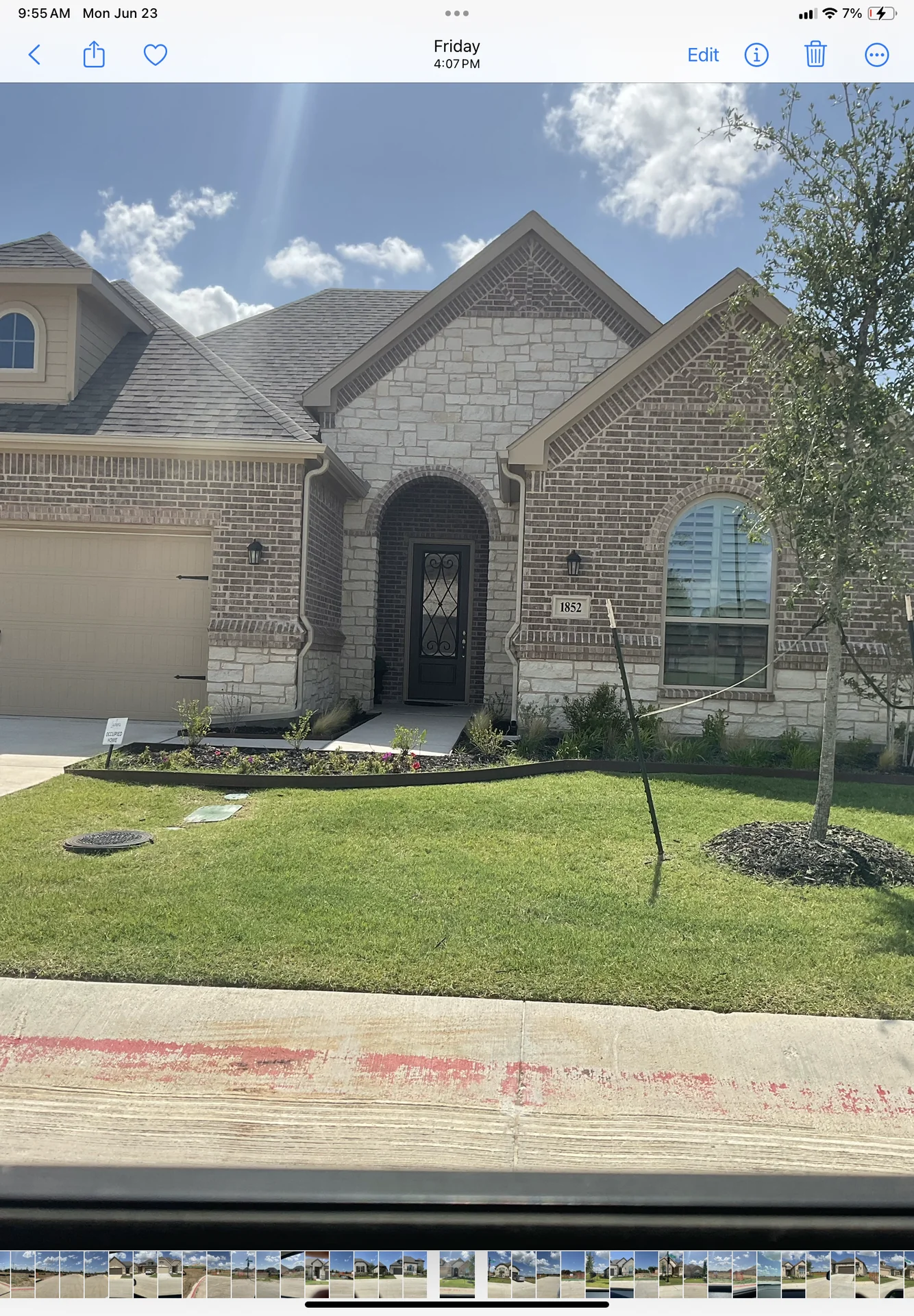 HOA-compliant xeriscaping with stone borders, dark mulch, and native Texas plants